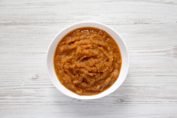 Homemade Raw Apple Sauce in a White Bowl, top view. From above, flat lay, overhead.