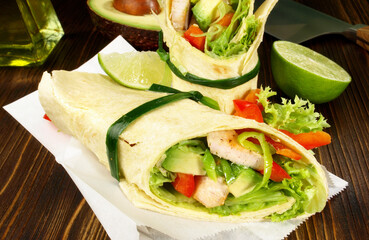 Chicken Wrap with Avocado on wooden Background
