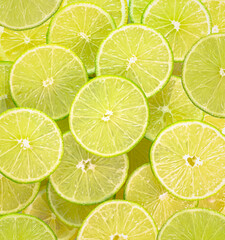 Fototapeta na wymiar Group of sliced limes background