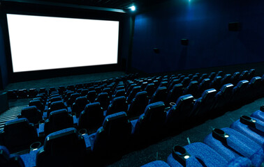 Empty movie theatre interior with screen and seats