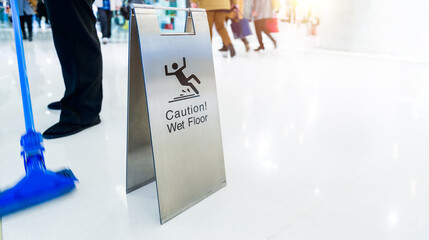 Cleaning in progress with wet floor caution sign besides