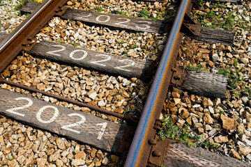 Number 2021 to 2023 on railroad track