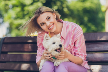 Photo of young attractive girl happy positive smile enjoy sit bench park puppy friendship owner walk outdoors