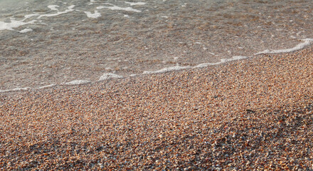 Beautiful seascape with beautiful sea waves and sea foam on shore with sea water on beach by sea