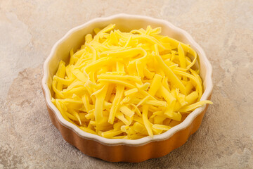Shredded yellow cheese in the bowl