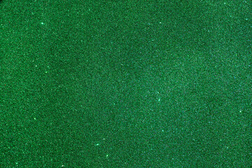 Bright green shiny background with yellow dots and stars. Green Christmas tree color. Christmas background. Christmas green for your photos