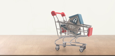 Toy shopping cart with Model of house and delivery concept