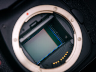 A shot of the CMOS sensor inside of a DSLR camera. Low key. Close up.