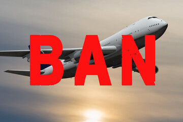 Red " Ban " sign on the background of a passenger plane flying in the sky. Concept: closing of air borders, restriction of flights, prohibited departure from the country, violation of air traffic.