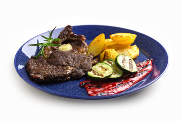 Grilled vegetables and beef steak on a plate. Delicious and healthy food. Isolate. Photo