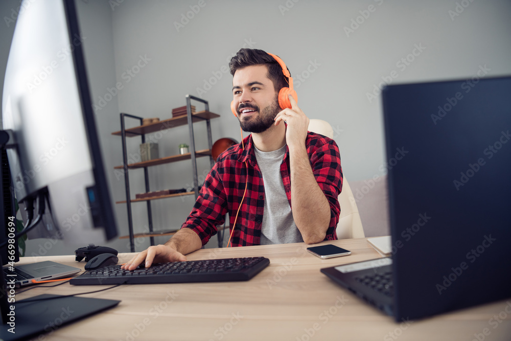 Poster portrait of attractive trendy cheery focused guy writing code e-mail script html at office workplace