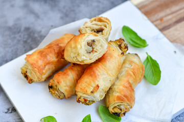  Greek style Mini filo pastry rolls with mushrooms.Home made bakery .Fresh baked  Mini cheese  ,meat and herbs puff pastries