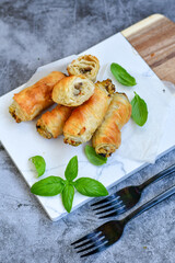  Greek style Mini filo pastry rolls with mushrooms.Home made bakery .Fresh baked  Mini cheese  ,meat and herbs puff pastries
