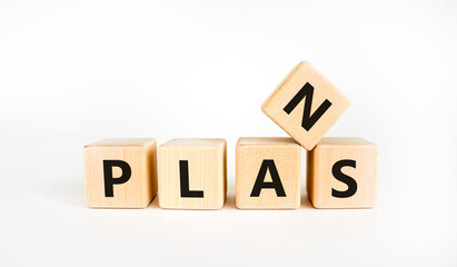 Plans symbol. The concept word 'plans' on wooden cubes on a beautiful white table. White background. Business and plan or plans concept.