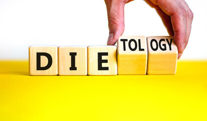 Dietology instead die symbol. Doctor turns wooden cubes and changes the word die to dietology. Beautiful yellow table, white background. Healthy lifestyle, dietology instead die concept. Copy space.