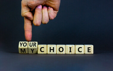 My or your choice symbol. Businessman turns wooden cubes and changes words 'my choice' to 'your choice'. Beautiful grey background, copy space. Business and my or your choice concept.