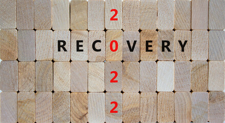 2022 recovery new year symbol. Wooden blocks with words 'Recovery 2022'. Beautiful wooden background, copy space. Business, 2022 recovery new year concept.