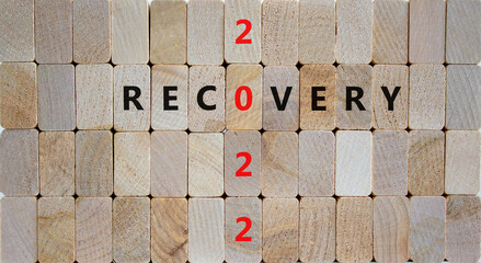 2022 recovery new year symbol. Wooden blocks with words 'Recovery 2022'. Beautiful wooden...
