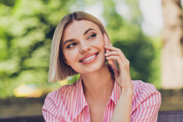 Photo of young attractive girl happy positive smile speak talk conversation smartphone mobile walk...