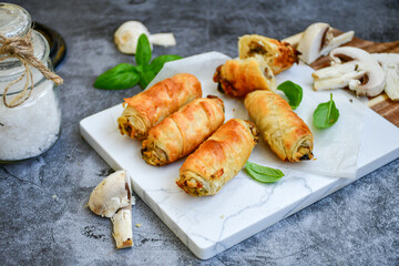  Greek style Mini filo pastry rolls with mushrooms.Home made bakery .Fresh baked  Mini cheese  ,meat and herbs puff pastries