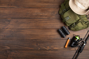 Fishing tackle - fishing spinning rod, hooks and lures on wooden background. Active hobby recreation concept.