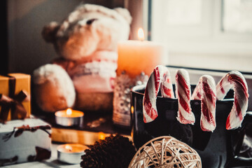 Soft toy and candles on wooden background with christmas decorations
