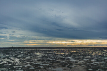 Fototapeta premium Low tide showing big area of mud sea in the evening.