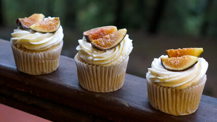 three cupcakes on a black background