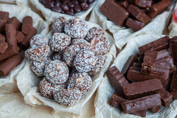 Assorted chocolate candies on wooden background. Chocolate sweets. Dessert background.