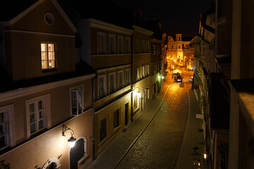 Night view of european old city street from an open window