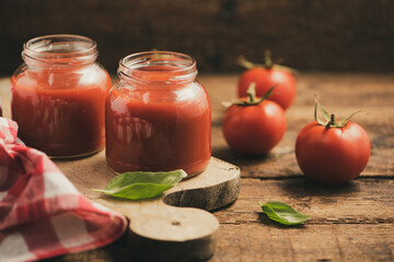 Jar of home made classic Tomato sauce on wooden table