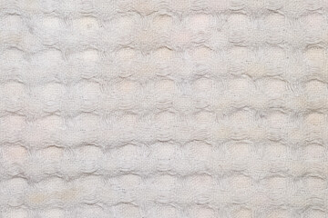Macro photo of patterned knitted circular beige textile