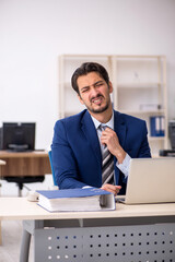 Young male employee working in the office
