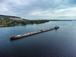 Fototapeta na wymiar Aerial view of loaded dry cargo ship on river.