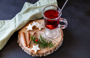 Mulled wine with spices and cinnamon stars on the wooden background