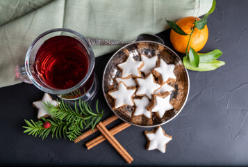 Mulled wine with spices and cinnamon stars on the dark background