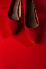 Red high-heeled shoes on a red background. stiletto
