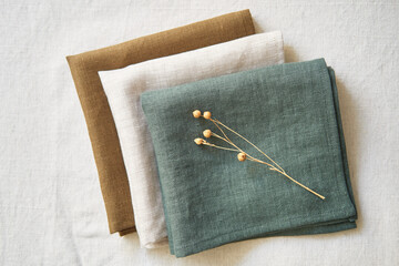 Collection of natural linen kitchen towels stacked neatly in a horizontally. Natural, soft and...