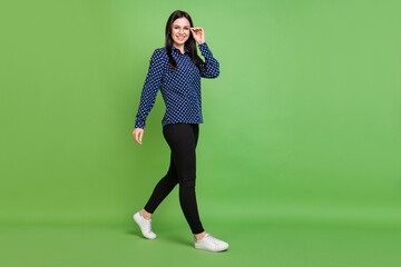 Full body profile photo of business lady go wear spectacles blue shirt trousers isolated on green color background