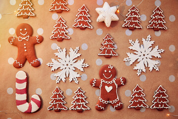 Fototapeta na wymiar Christmas homemade gingerbread cookies pattern. Homemade baking background. Festive card with aesthetic Christmas atmosphere. Merry Christmas and home coziness concept