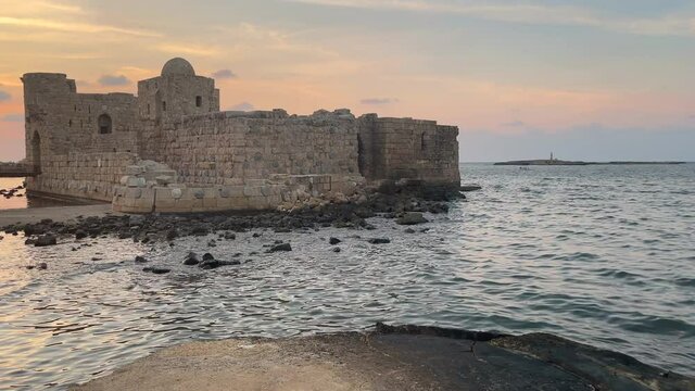 The city of Sidon in Lebanon. Sidon Sea Castle, built by the crusaders - Saida corniche and building. Sidon sea at sunset