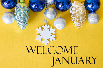 Welcome january text on Christmas background, Christmas decorations on yellow background