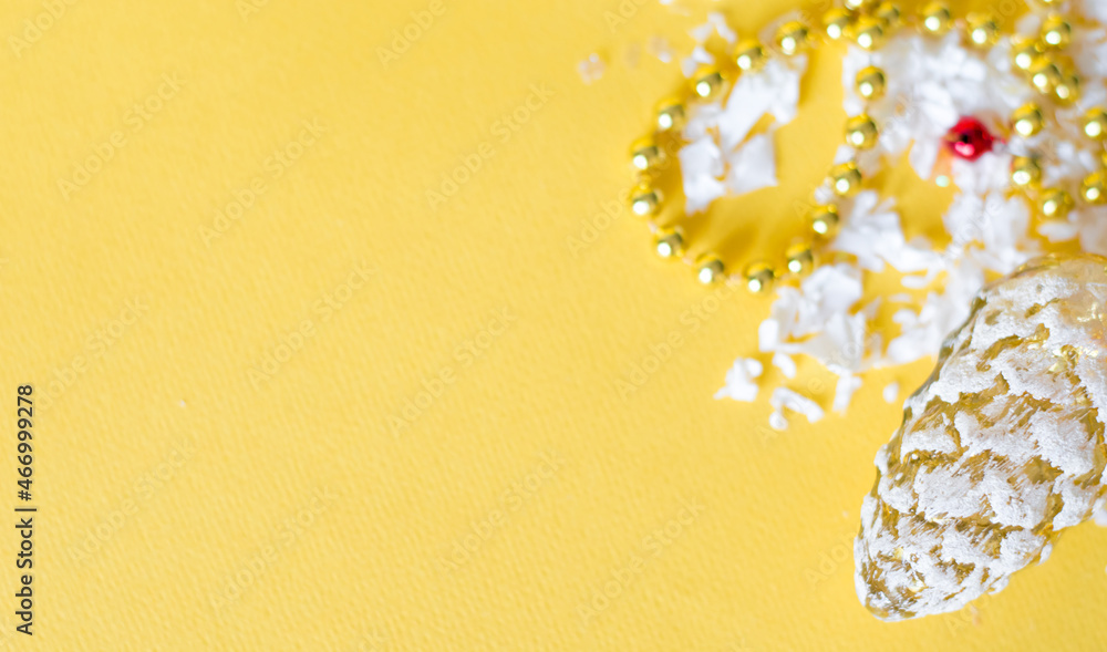 Poster old christmas tree toy in the form of a cone beads on yellow background, festive background with emp