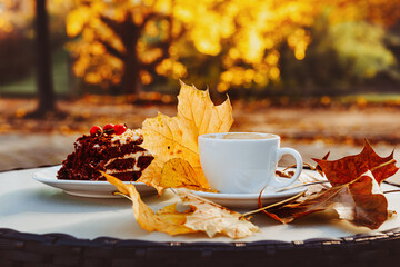 Naklejka na ściany i meble Cup with coffee and cake on the background of the autumn 