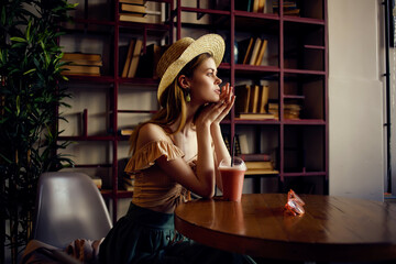 cheerful woman with a book in the hands of a cafe fashion