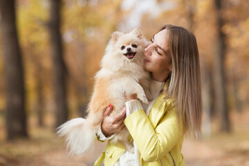 young beautiful woman with dog  in the autumn outdoor