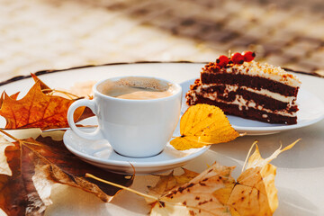 Cup with coffee and cake on the background of the autumn 