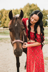 girl in red dress with horse 