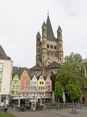 Obraz premium Tower of Great Saint martin church and facades of mdieval houses in Cologne.