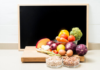 Still life with healthy food and a blackboard with space for copying.